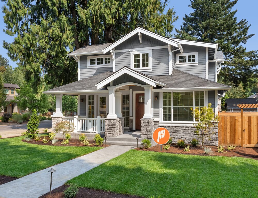 A finished Phase One advertising home with a small yard sign in the front yard